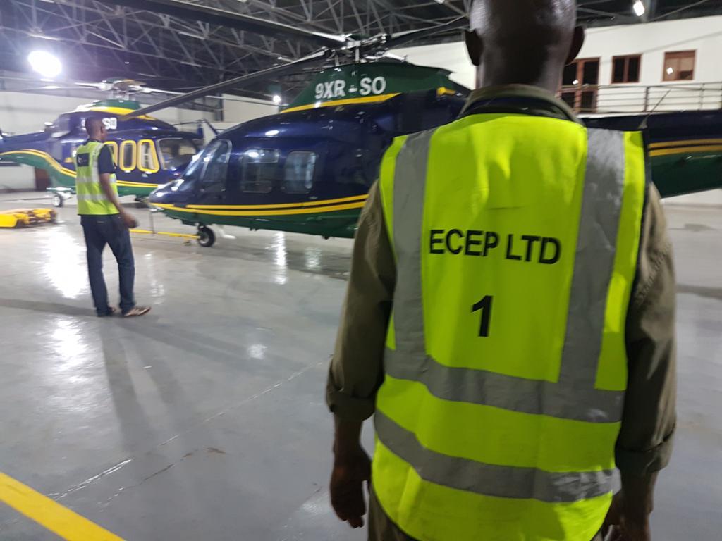 ECEP Ltd team in branded vests with helicopters — Akagera Aviation project