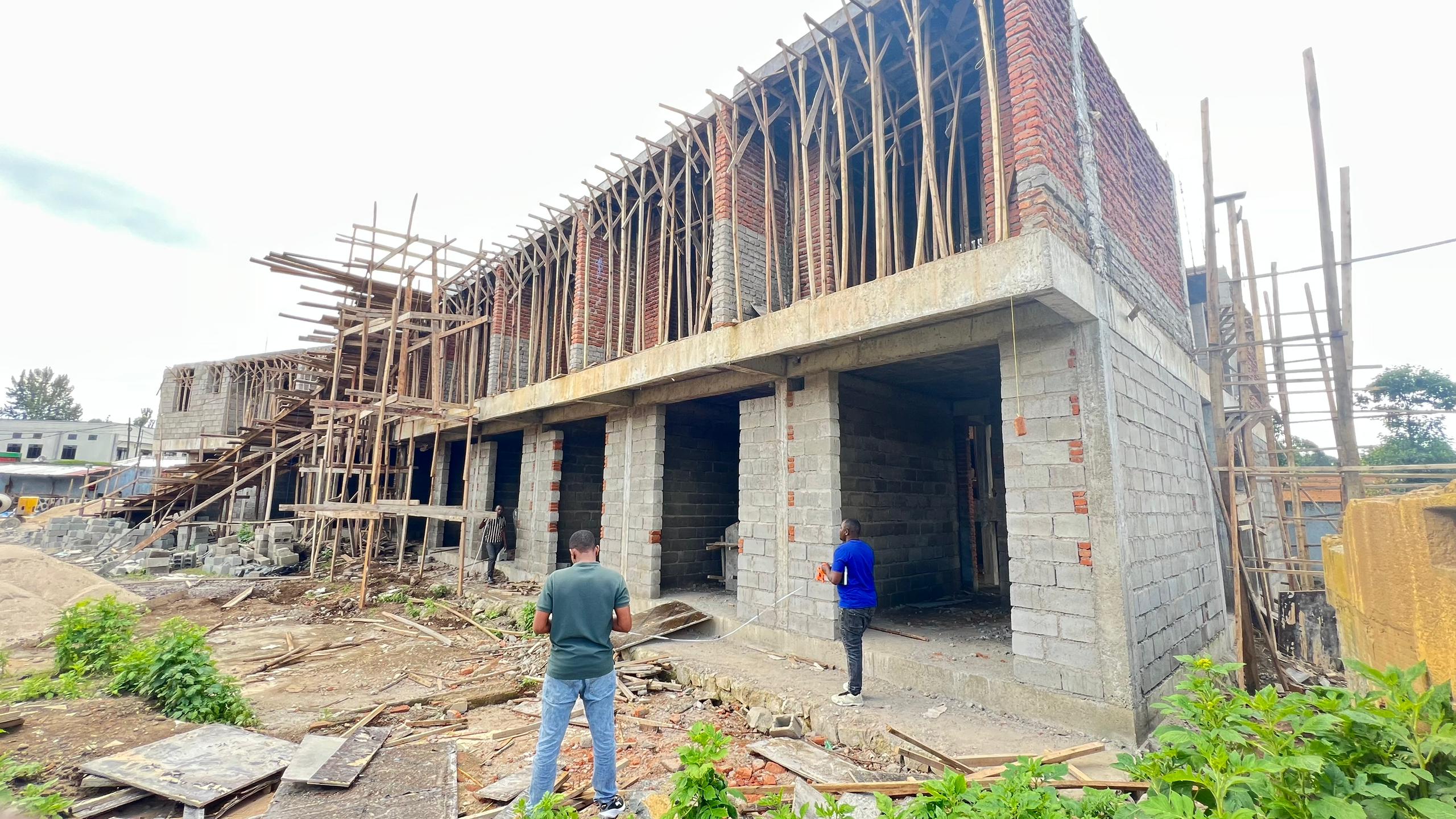Brick and block building under construction with workers on site